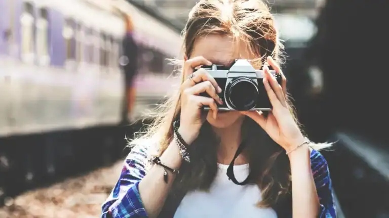 Picture of a girl holding up a camera taking a picture