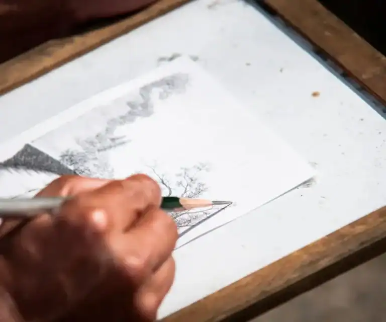 person sketching on paper
