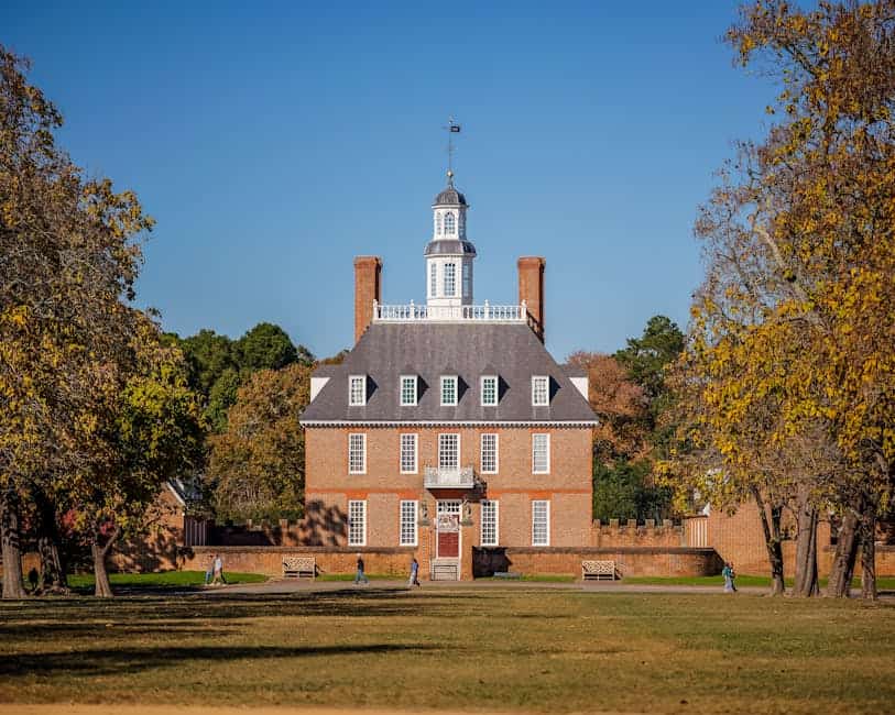 Historic Governor's Palace in Colonial Williamsburg surrounded by autumn foliage.