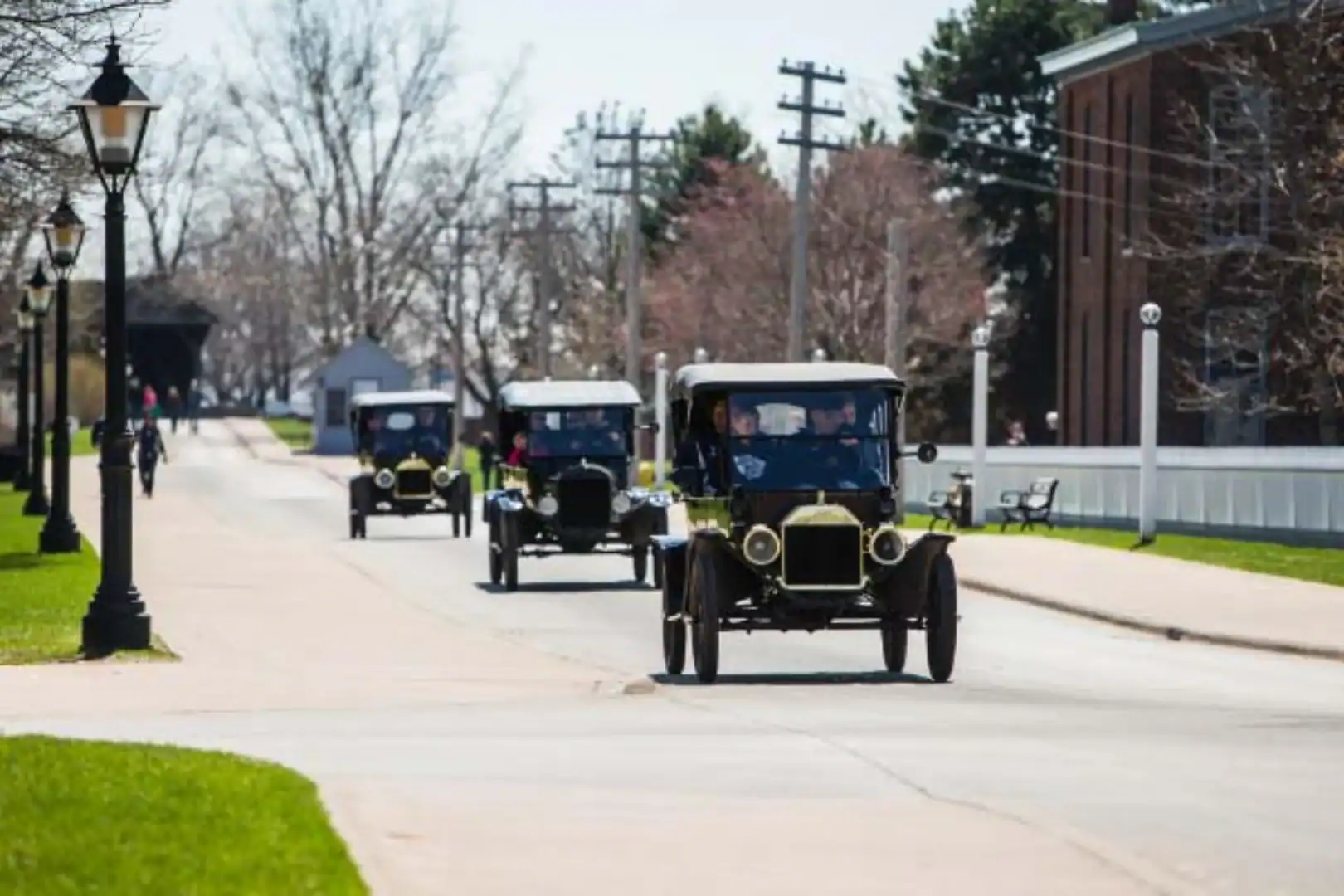 Old fashion cars driving down the road